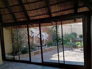 Before and after photos of steel window removed and replcement with aluminium windows